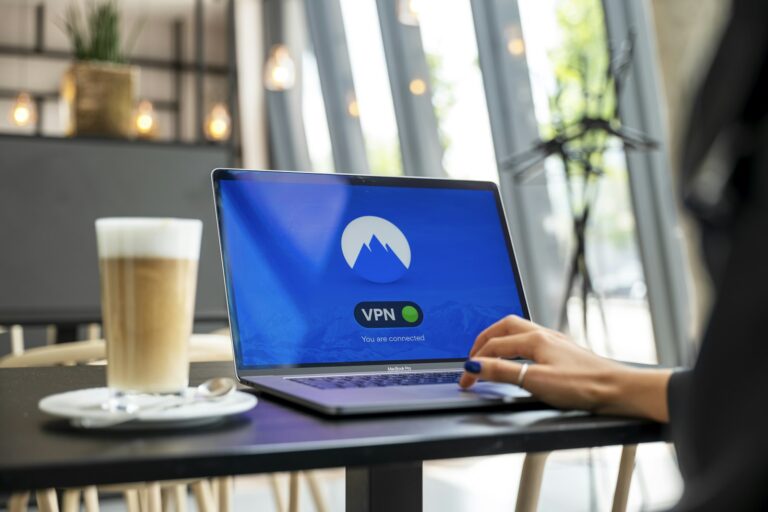 Traveler connecting to a VPN on a laptop in a cafe