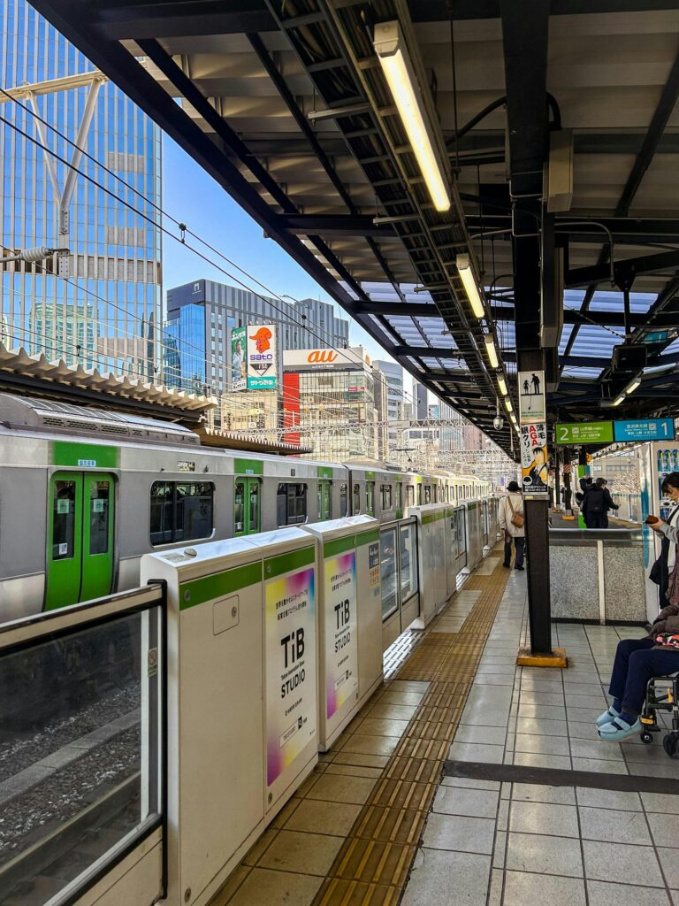 Green-striped Yamanote Line train at a platform in Tokyo