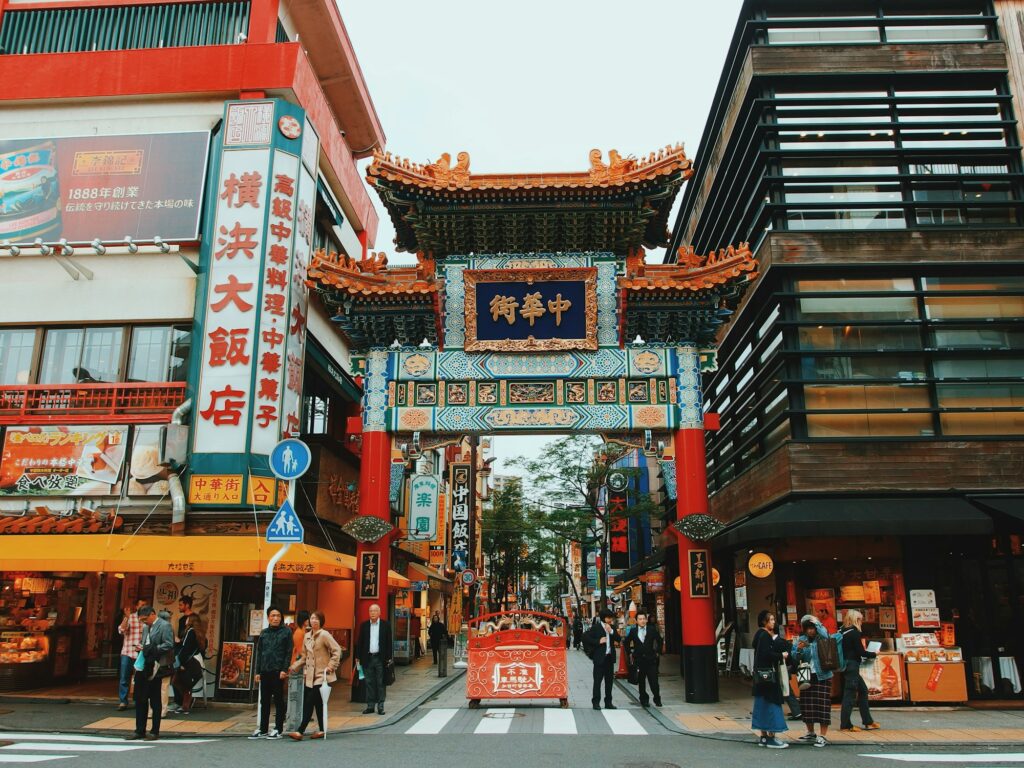Ornate gate at the entrance to Yokohama Chinatown with shops and restaurants