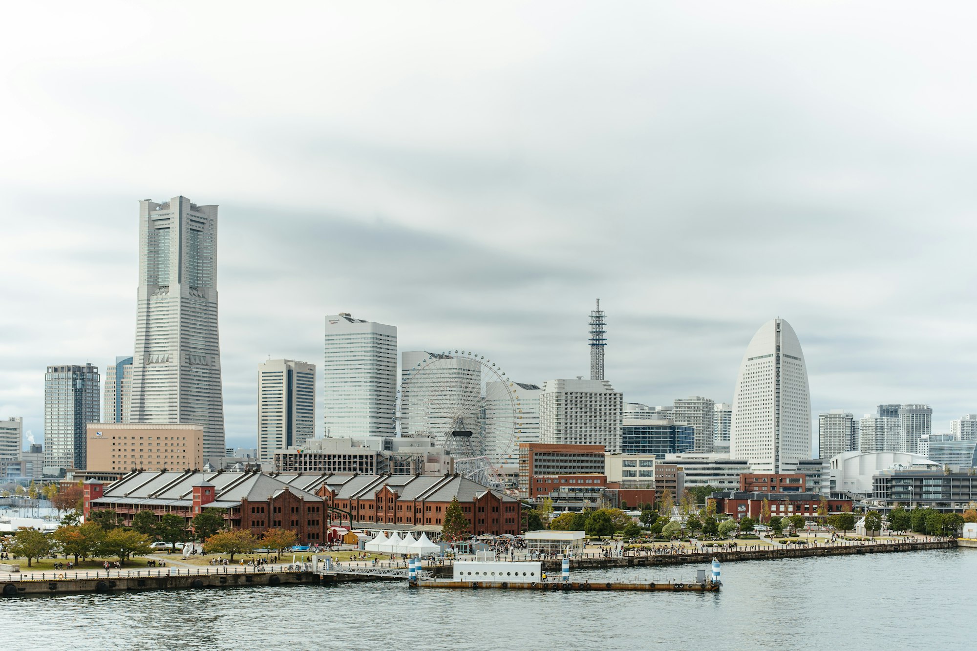 Yokohama Minato Mirai skyline with Landmark Tower and the Red Brick Warehouse from the harbor