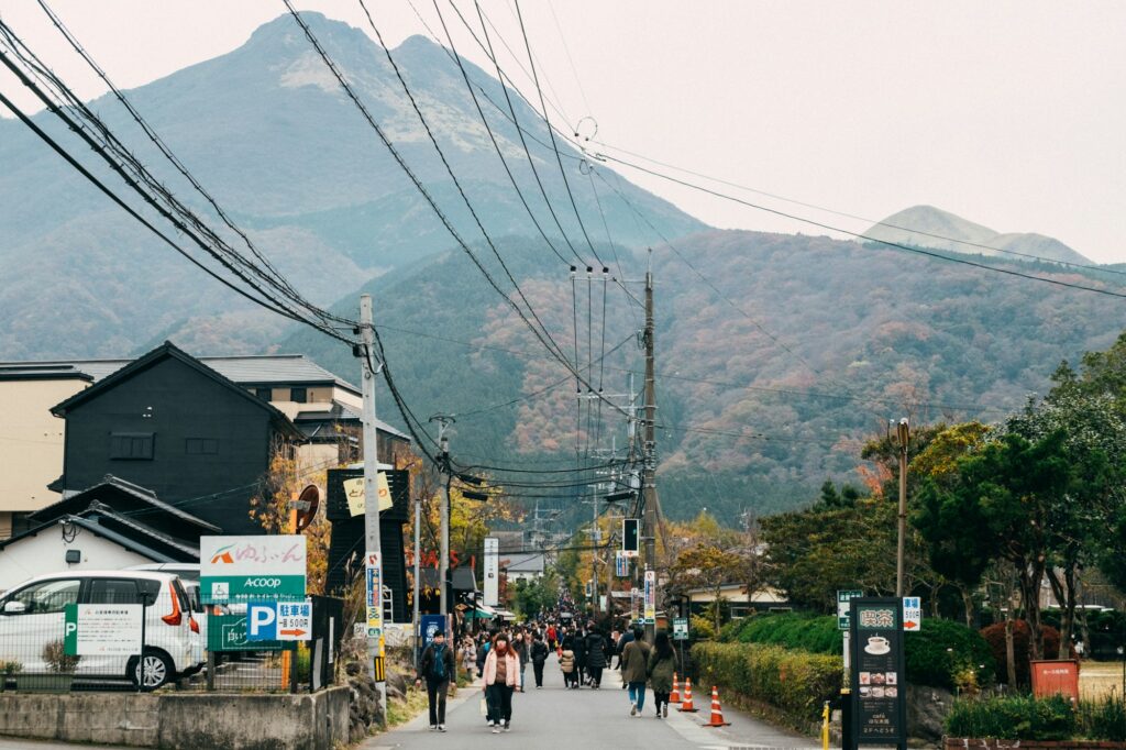 A Yufuin street with the twin peaks of Mount Yufu behind